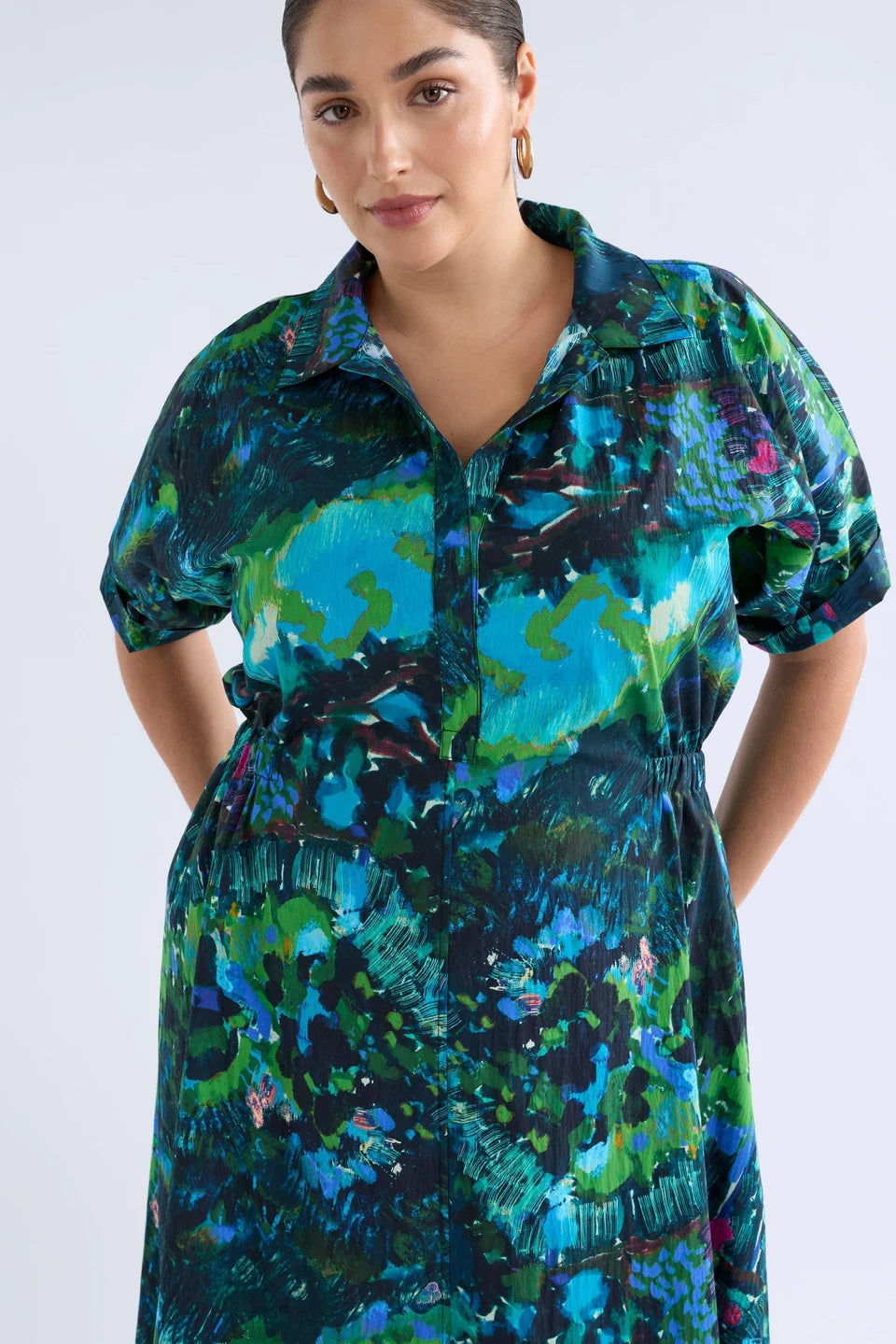 Elk Bohn shirt dress short-sleeve collared with a vibrant abstract floral print in shades of teal, green, blue, and black.