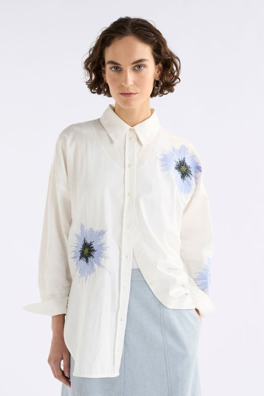 Elk Eiren relaxed white cotton poplin shirt with embroidered blue floral motifs.