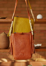 Load image into Gallery viewer, Nancybird Form pouch leather phone bag in mustard yellow with beads and tassel detail.