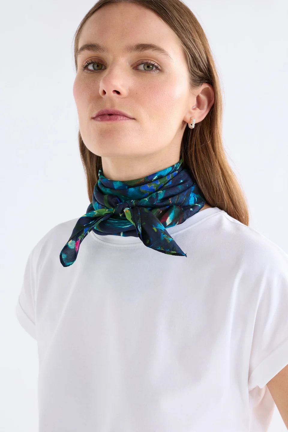 Elk Landskap silk square scarf with an abstract, painterly pattern in shades of teal, green, black, and bright pink accents.