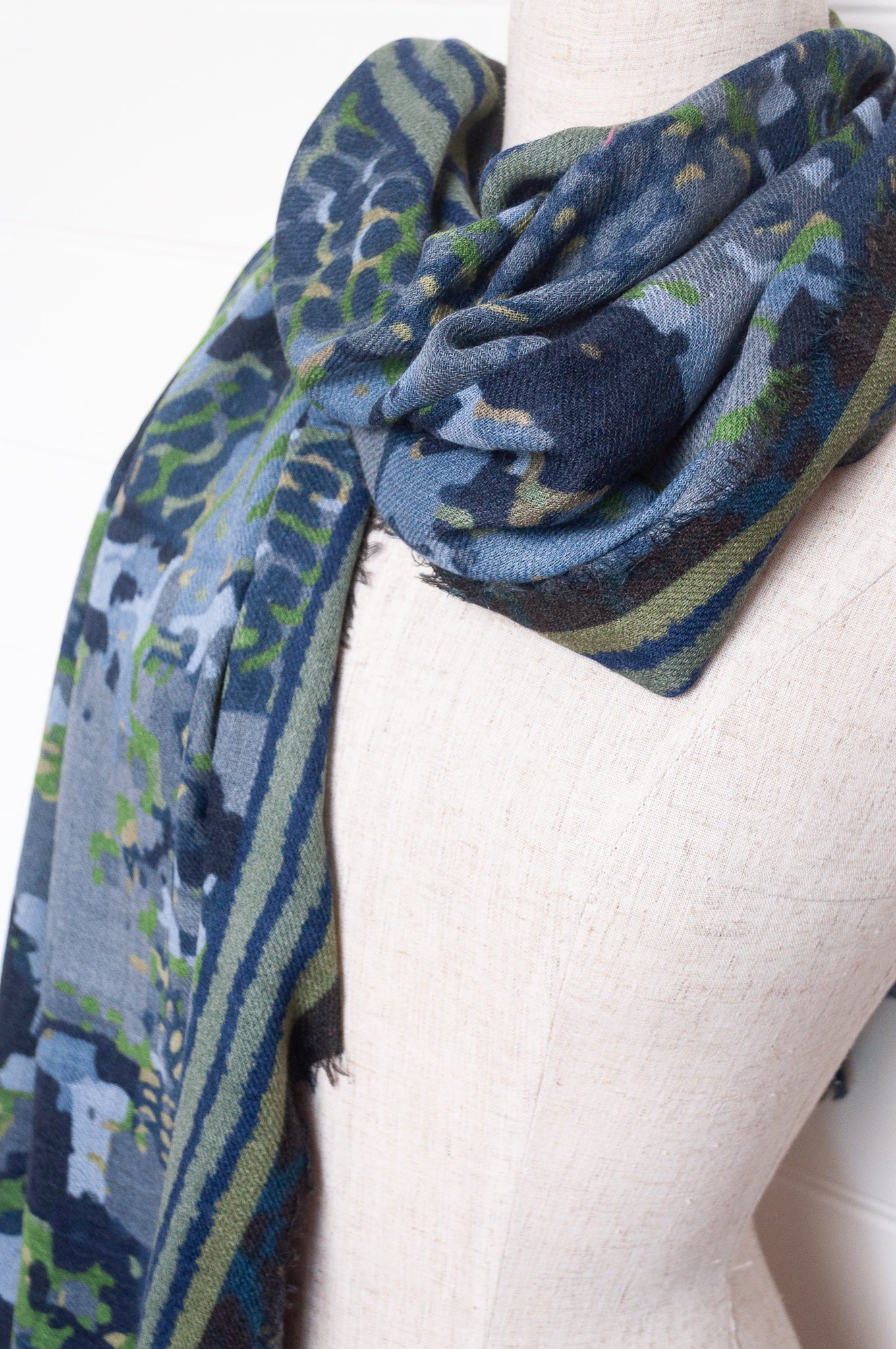 Fine wool modal scarf in bluel and green pixeallated camouflage print.