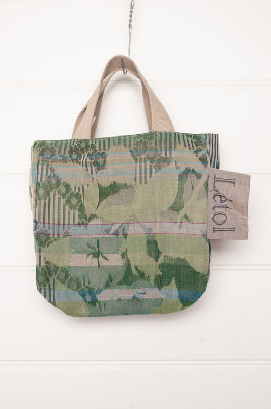 Letol organic cotton jacquard weave mini tote bag in flowers and foliage in greens and turquoise.