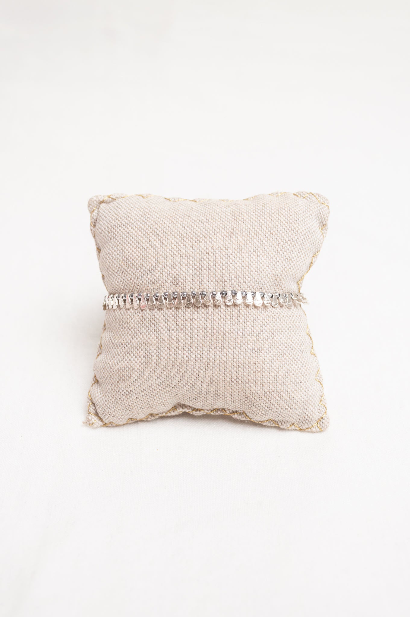 Mary Gaitani made in Greece waxed cord bracelet with silver charms, semi-precious stones and tiny tassel.