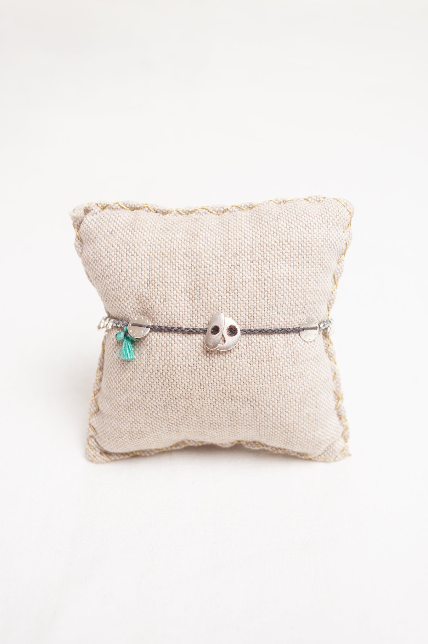 Mary Gaitani made in Greece waxed cord bracelet with silver charms, semi-precious stones and tiny tassel.