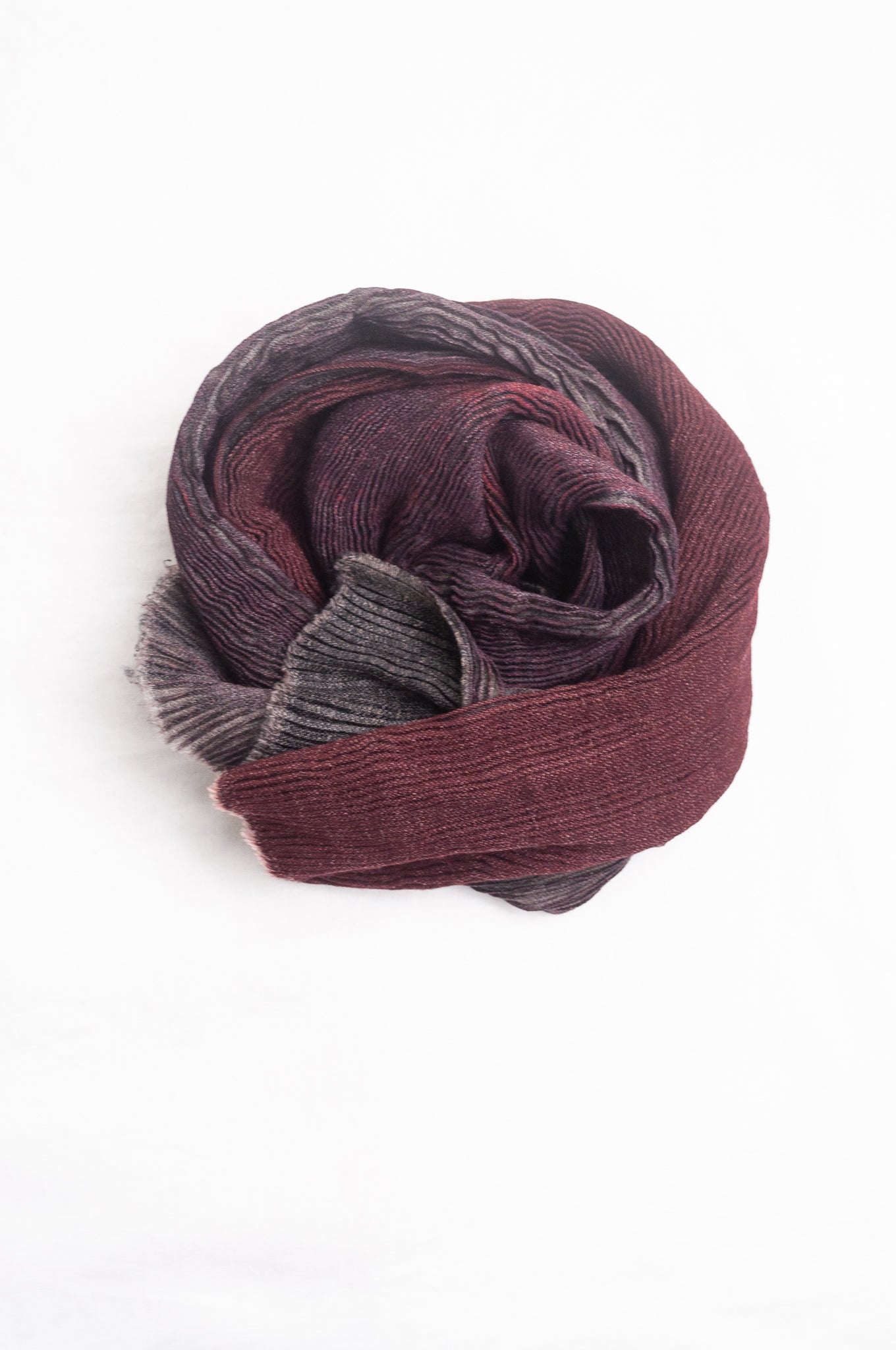 NK Shibori dyed wool scarf in wine red and charocal, pleat finish.