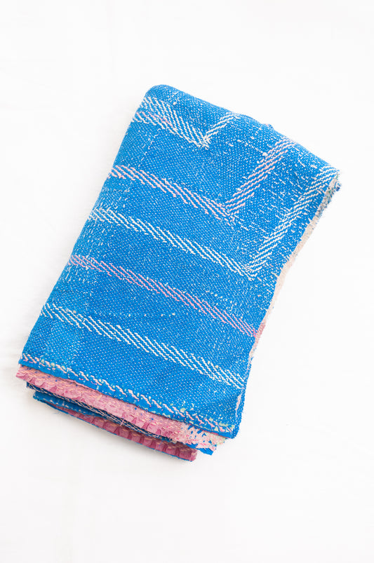 Vintage kantha quilt in cobalt blue stitched in pink and white.