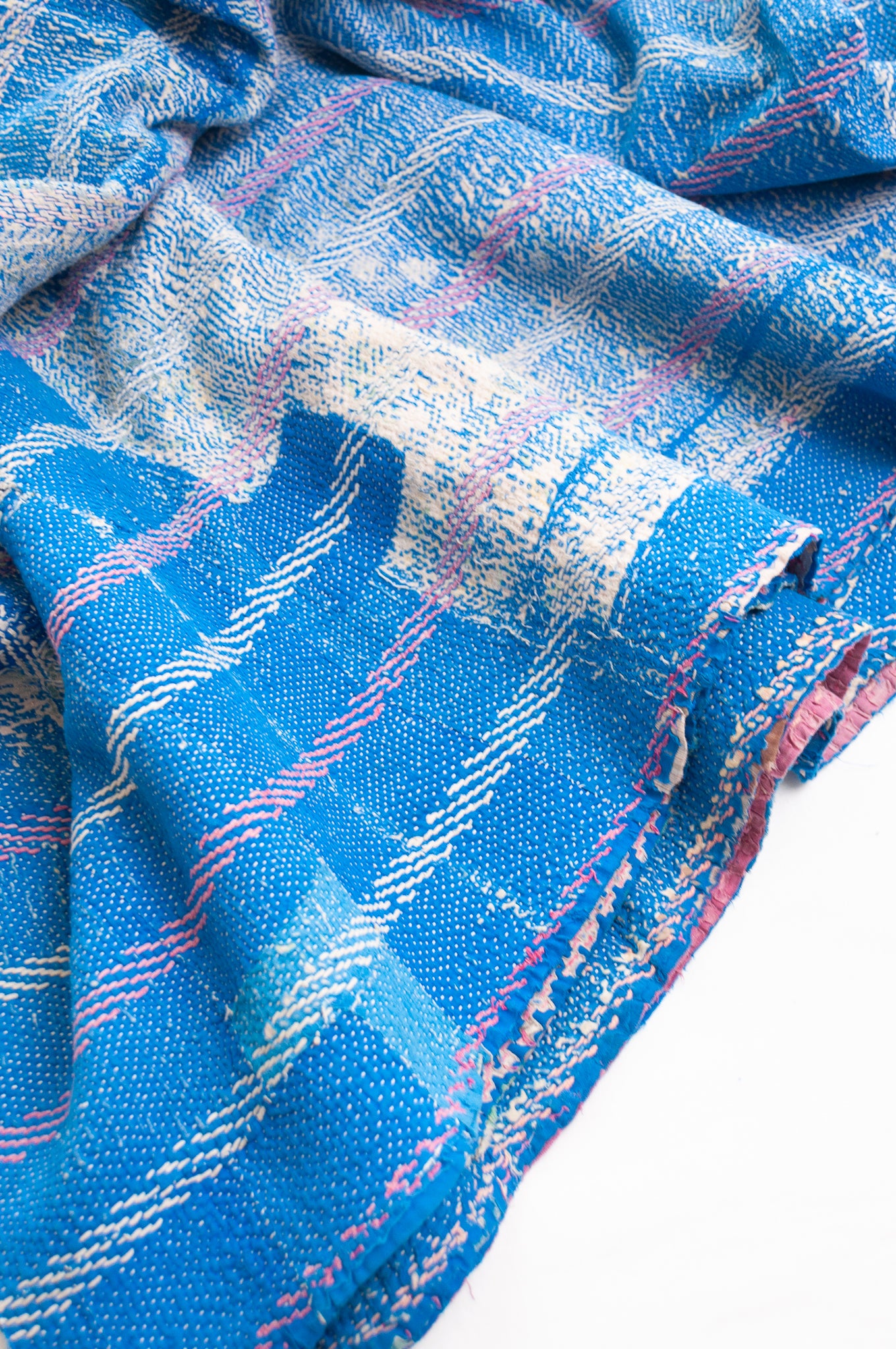 Vintage kantha quilt in cobalt blue stitched in pink and white.