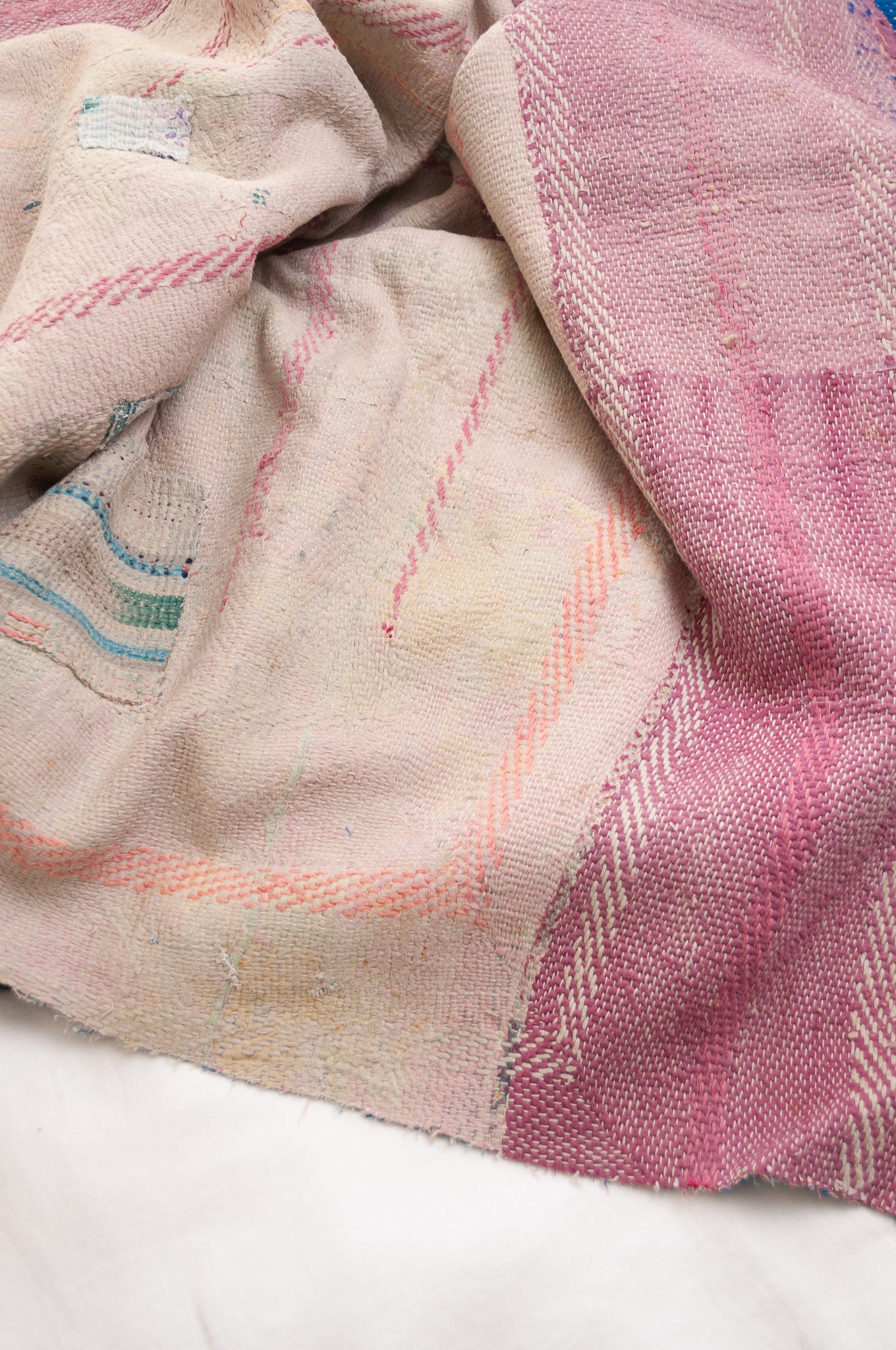 Vintage kantha quilt in cobalt blue stitched in pink and white.