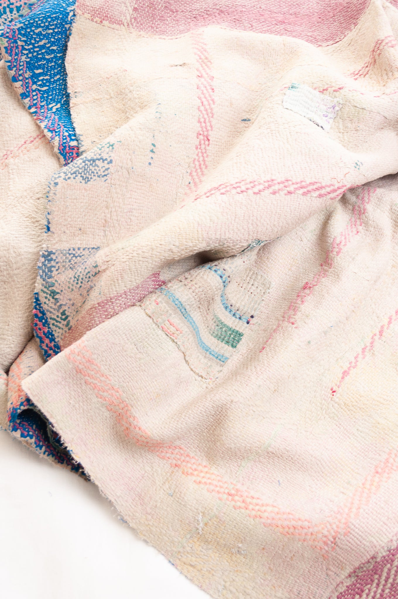 Vintage kantha quilt in cobalt blue stitched in pink and white.