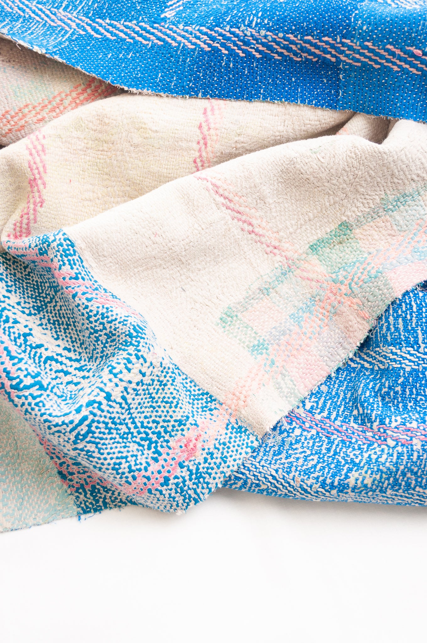 Vintage kantha quilt in cobalt blue stitched in pink and white.