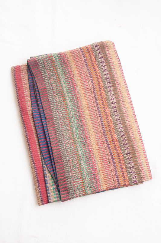 Vintage kantha quilt in deep pink, blue and green, and floral braid stripes.
