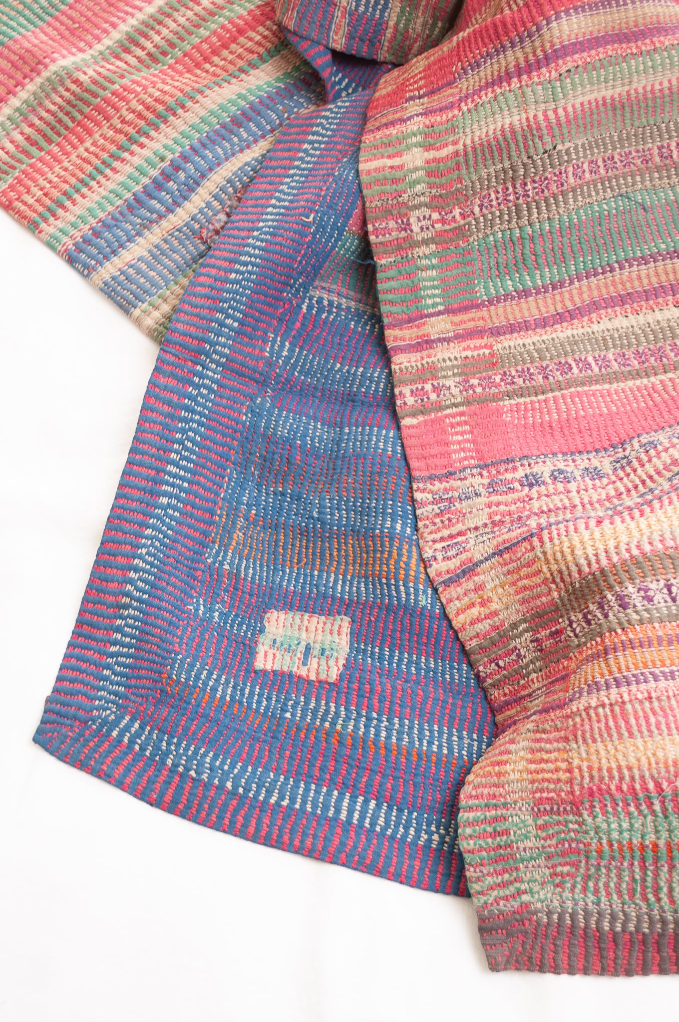 Vintage kantha quilt in deep pink, blue and green, and floral braid stripes.