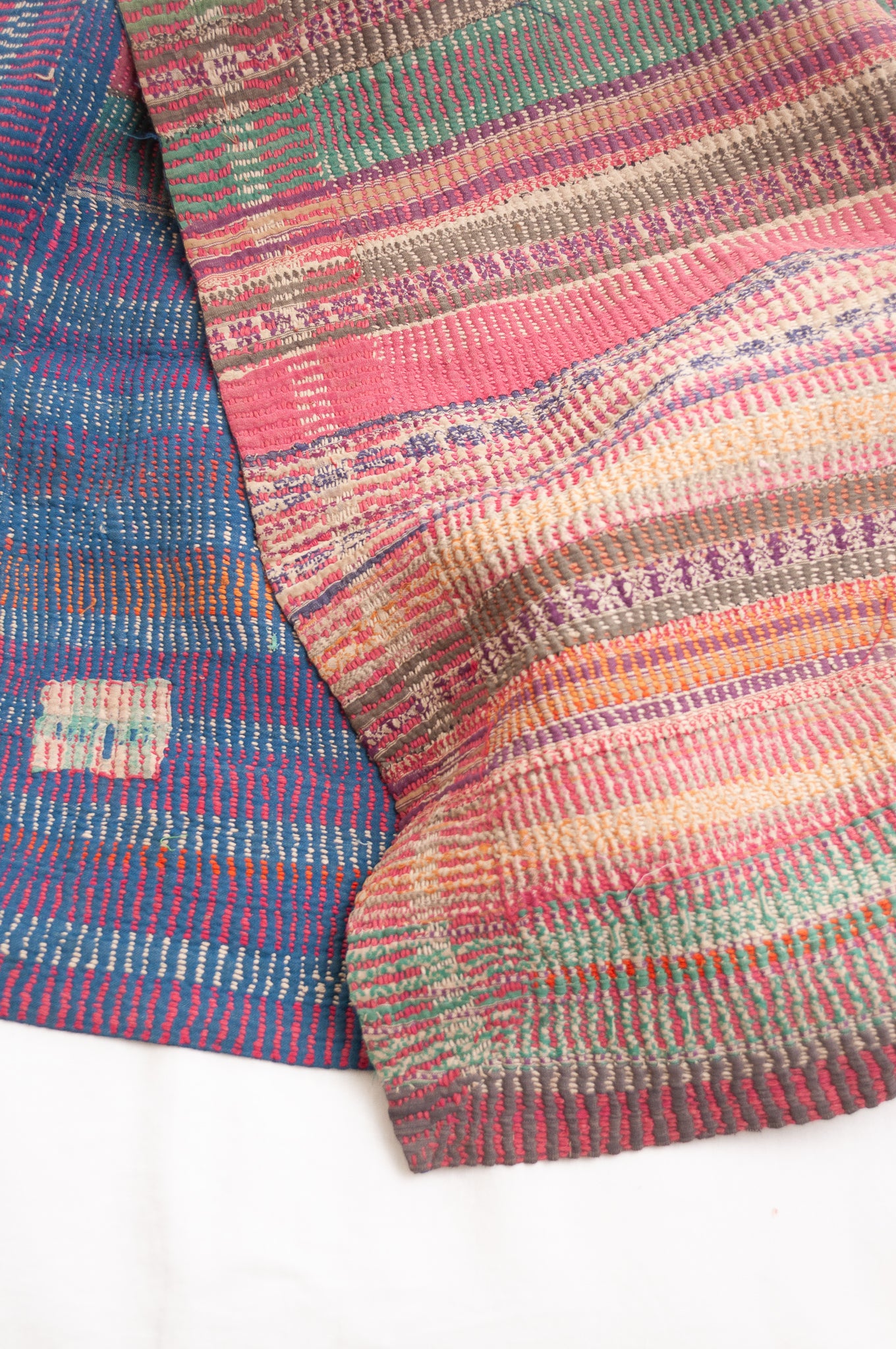 Vintage kantha quilt in deep pink, blue and green, and floral braid stripes.
