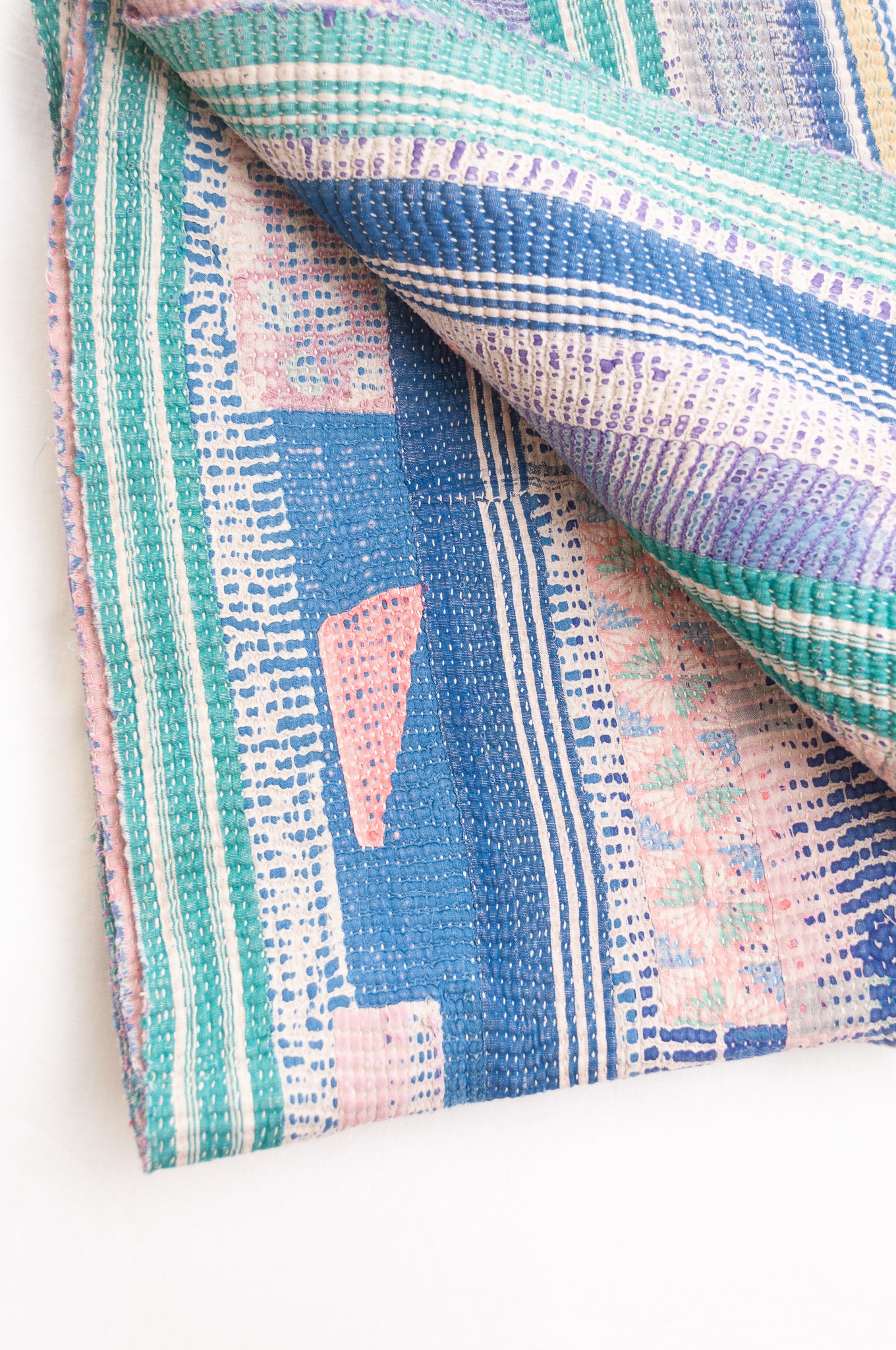 Vintage kantha quilt in deep pink, bluel lavender and green stripes.