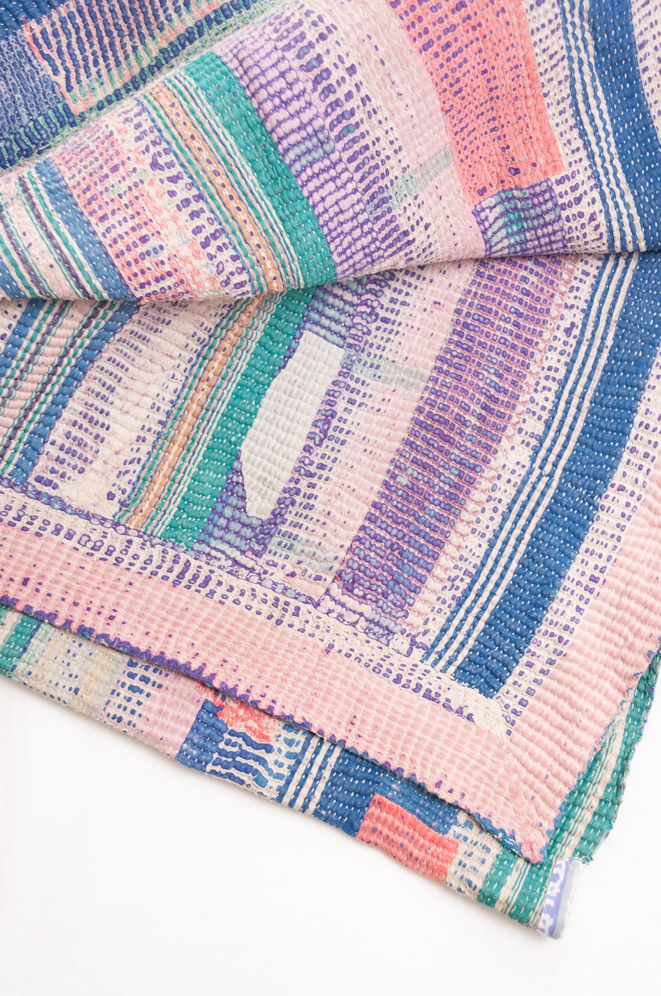 Vintage kantha quilt in deep pink, bluel lavender and green stripes.