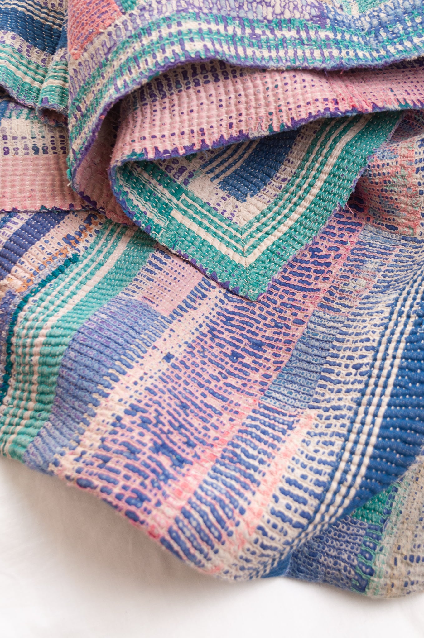 Vintage kantha quilt in deep pink, bluel lavender and green stripes.