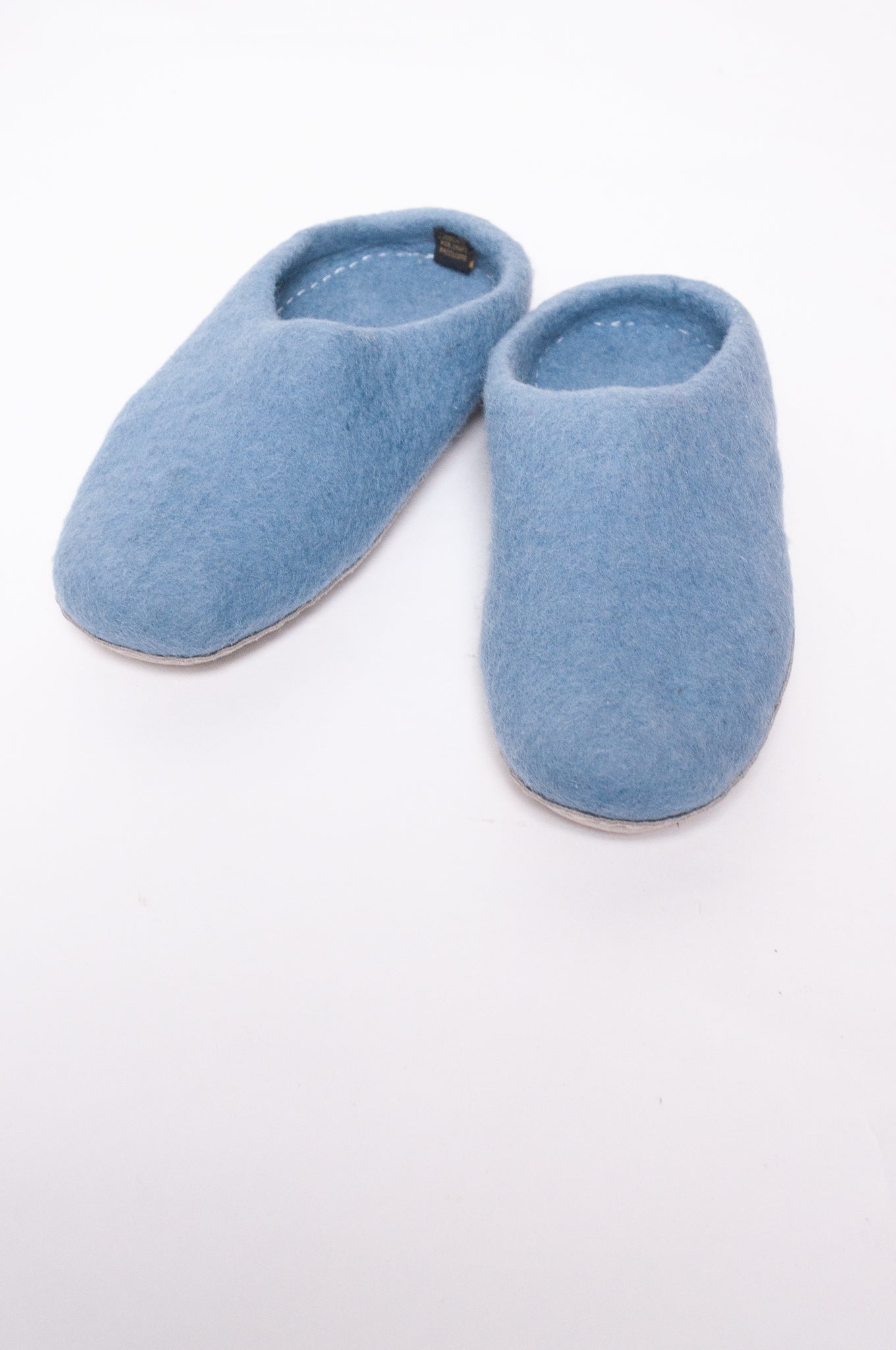 Wool felt slip on slippers in baby blue.