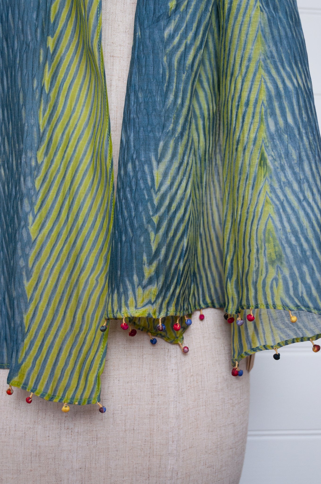 Neeru Kumar shibori dyed cotton silk scarf in blue and green with fabric beads.