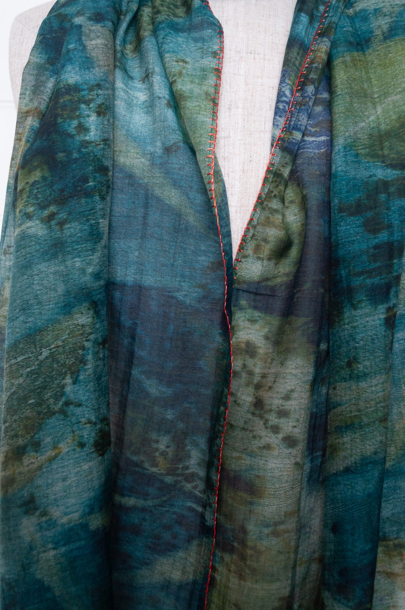Neeru Kumar cotton silk scarf in blue and green with embroidered edging and tiny tassels.