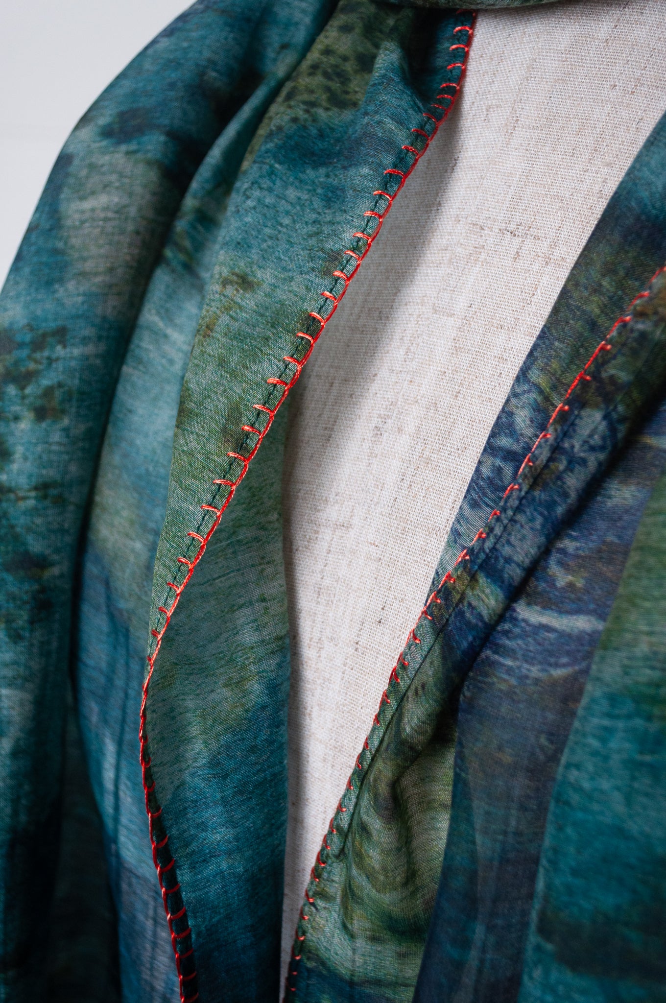 Neeru Kumar cotton silk scarf in blue and green with embroidered edging and tiny tassels.