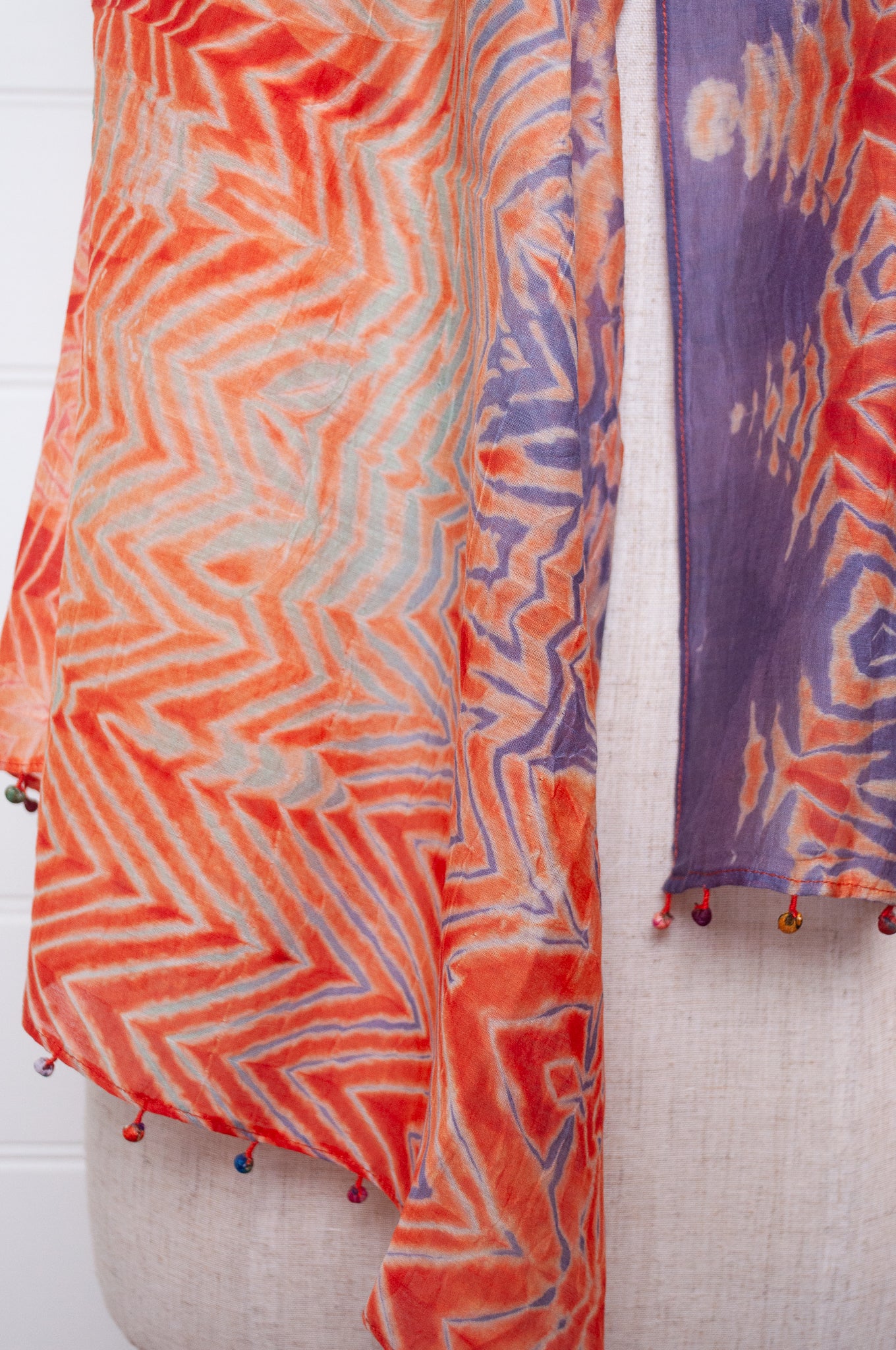 Neeru Kumar shibori dyed cotton silk scarf in orange with fabric beads.