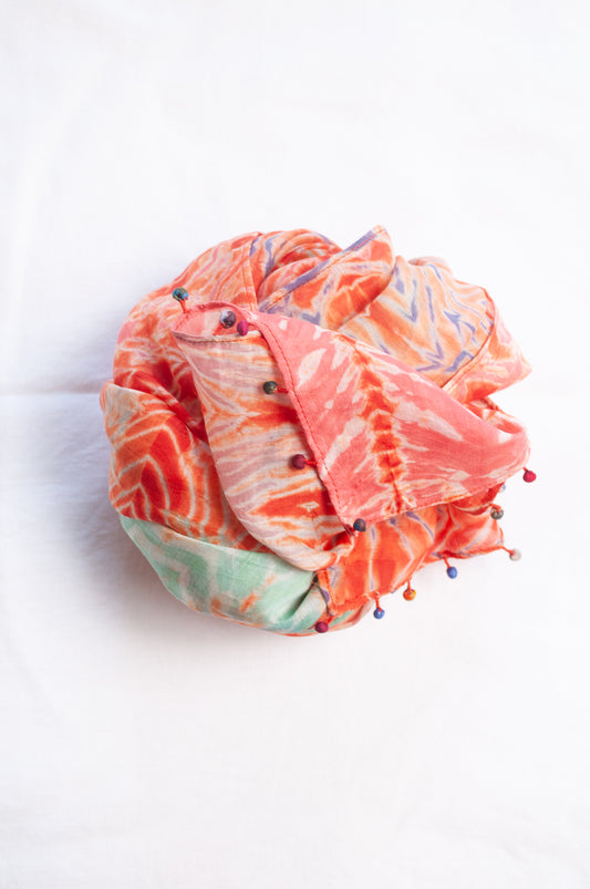 Neeru Kumar shibori dyed cotton silk scarf in orange with fabric beads.
