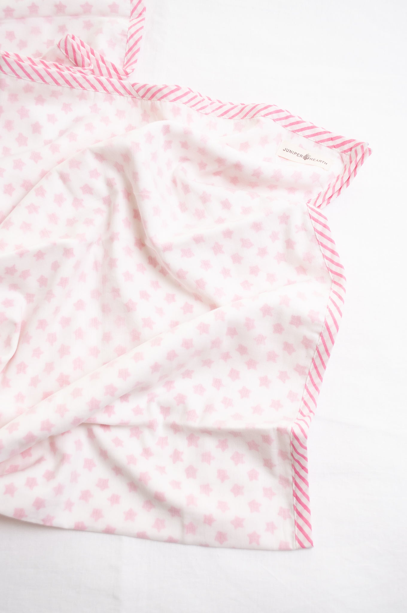 Baby dohar cot size cotton muslin block print pink stars on white.