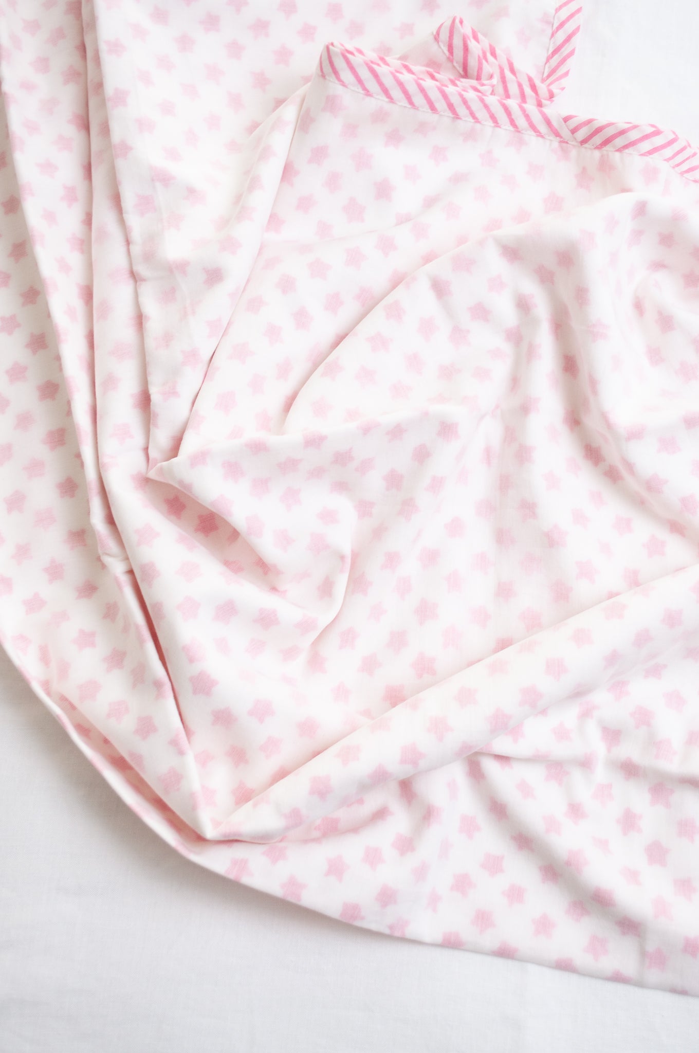 Baby dohar cot size cotton muslin block print pink stars on white.