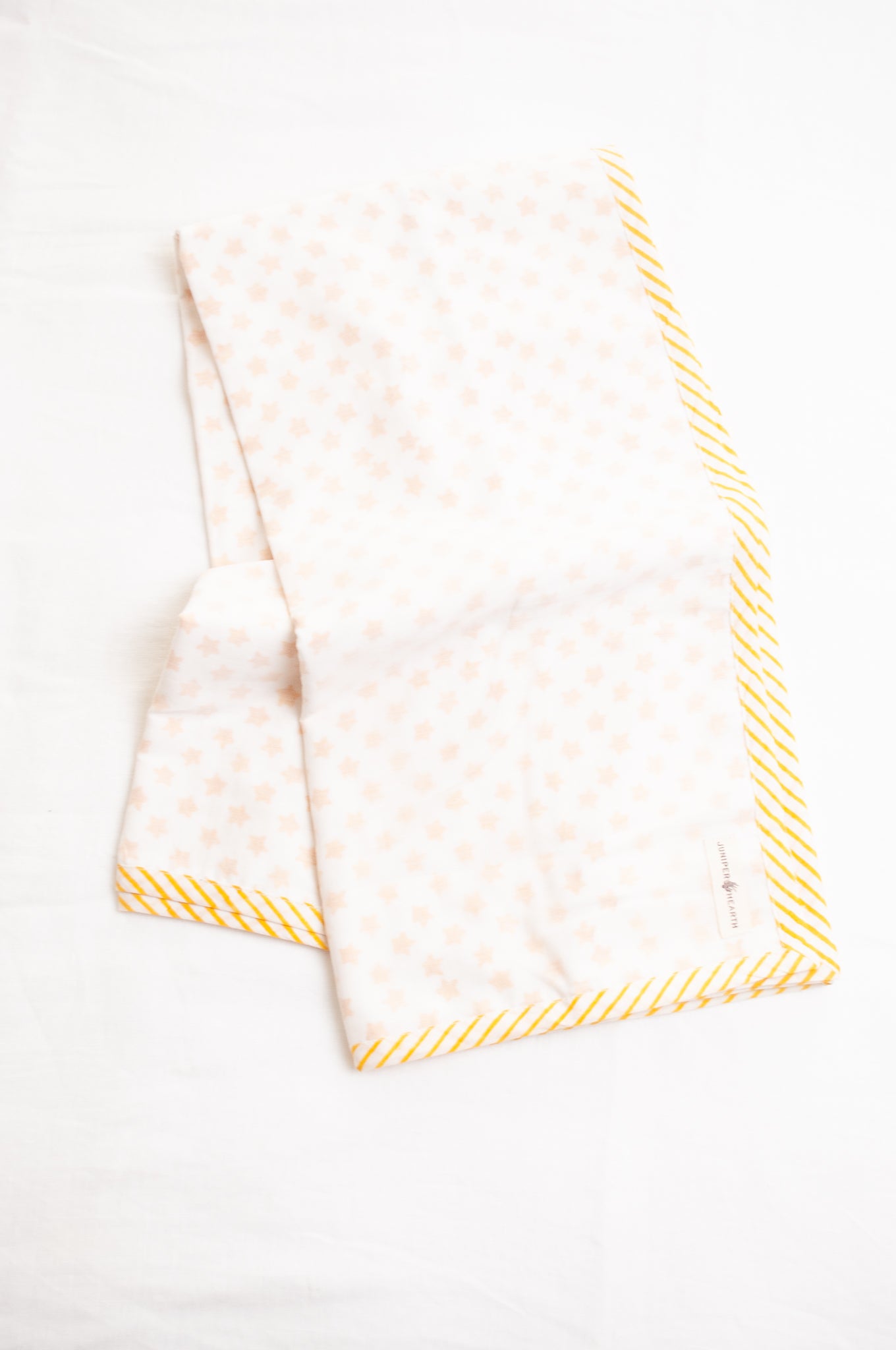 Baby dohar cot size cotton muslin block print yellow stars on white.