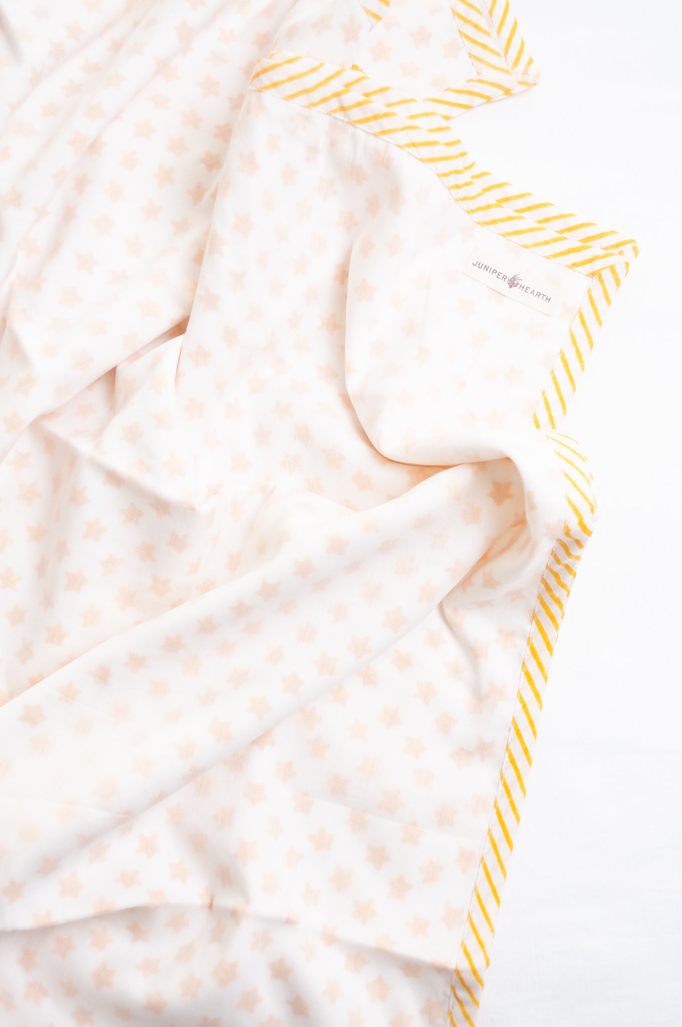 Baby dohar cot size cotton muslin block print yellow stars on white.