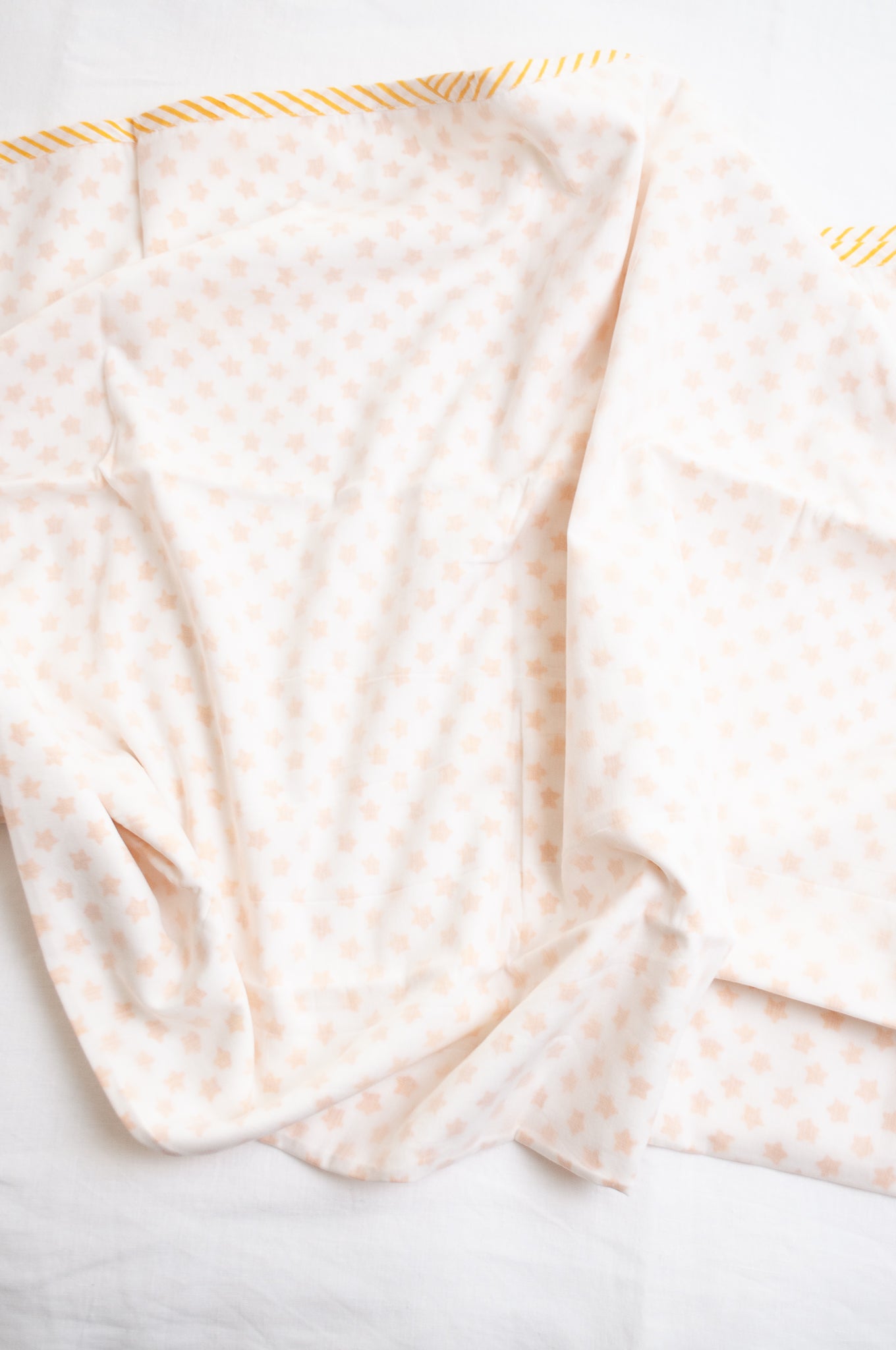 Baby dohar cot size cotton muslin block print yellow stars on white.