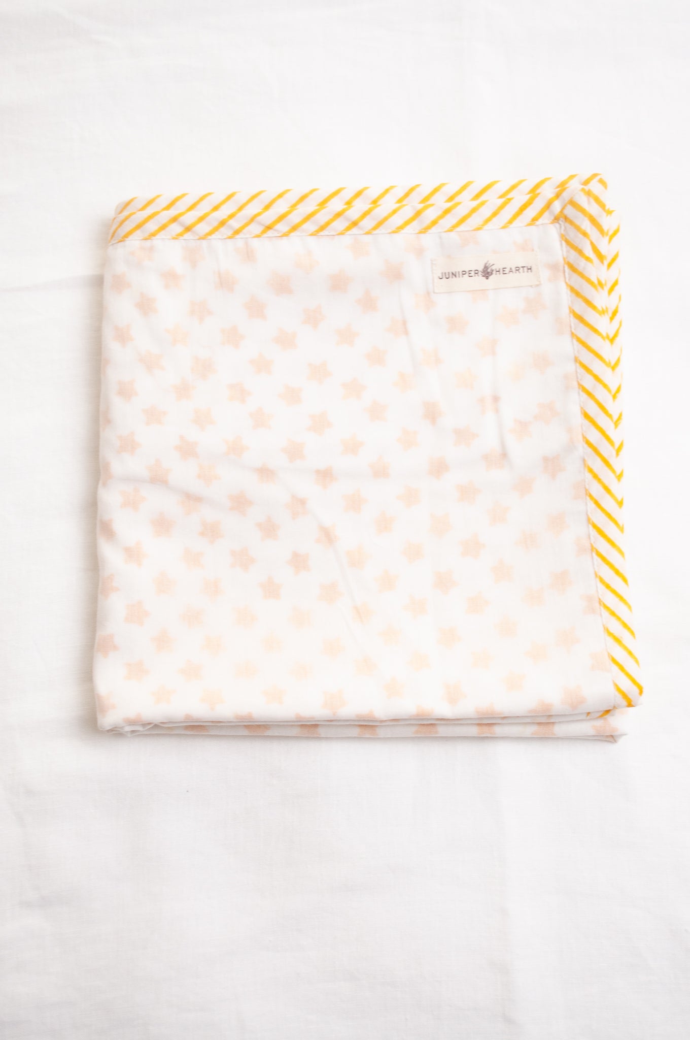 Baby dohar cot size cotton muslin block print yellow stars on white.