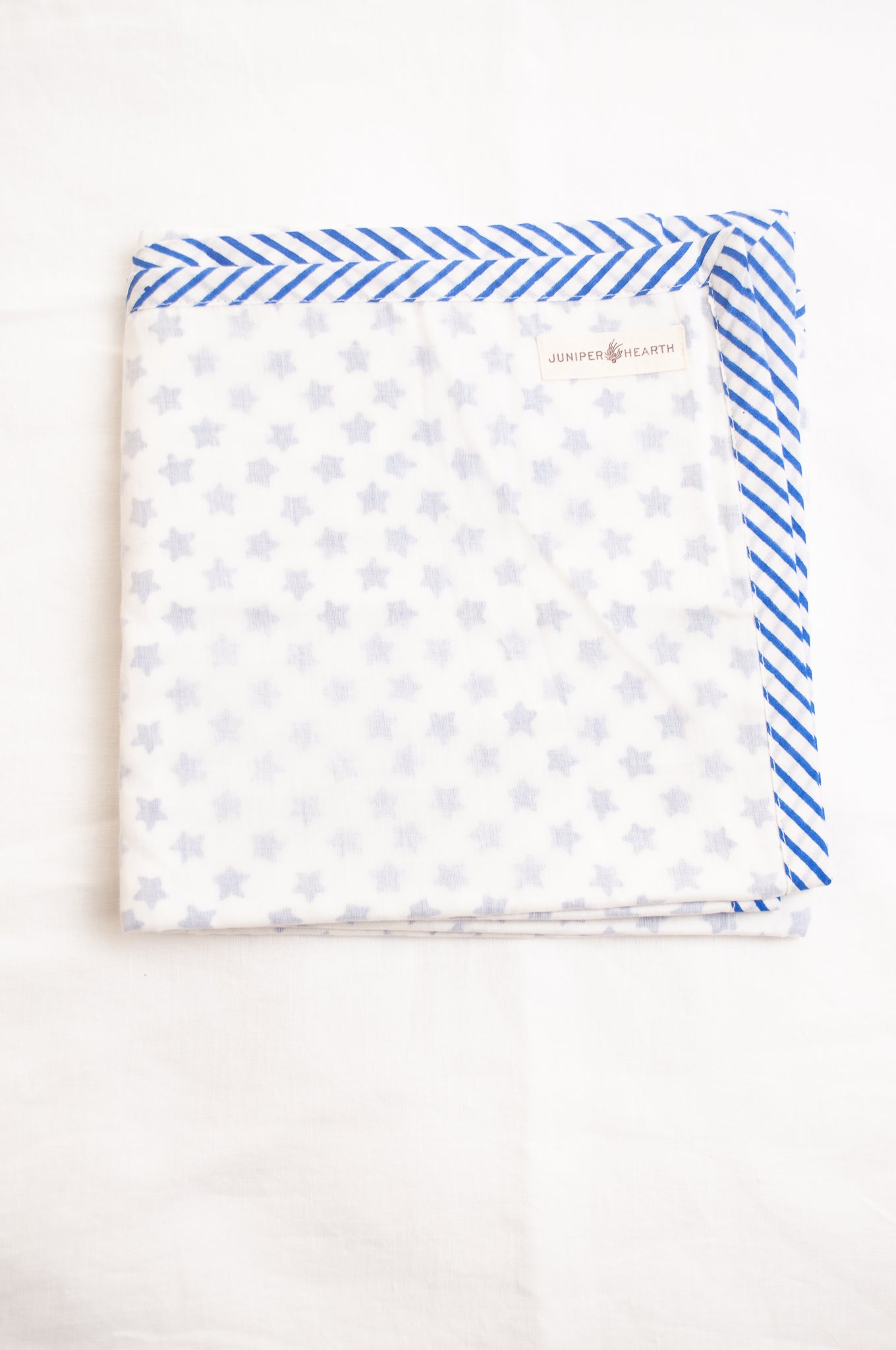 Baby dohar cot size cotton muslin block print blue stars on white.