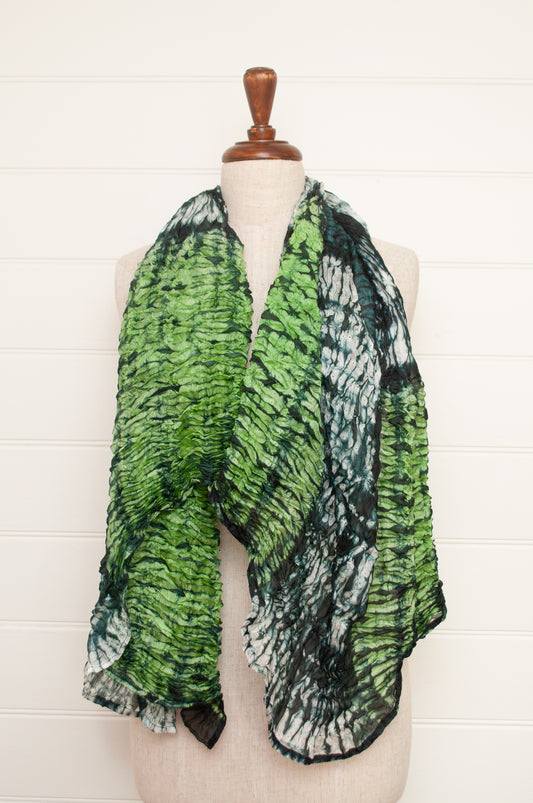 Shibori dyed pure silk crinkle finish scarf in shades of green, with stripes of navy and white.