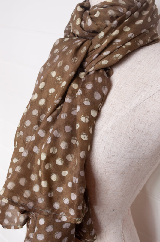 Pure silk shibori dyed scarf in deep olive green with white spots.