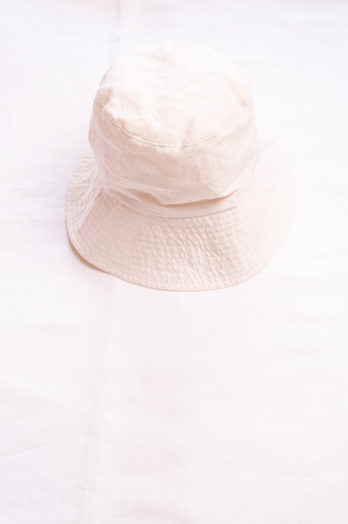 PCNQ Luna made in Japan ivory white foldable linen fabric bucket hat.