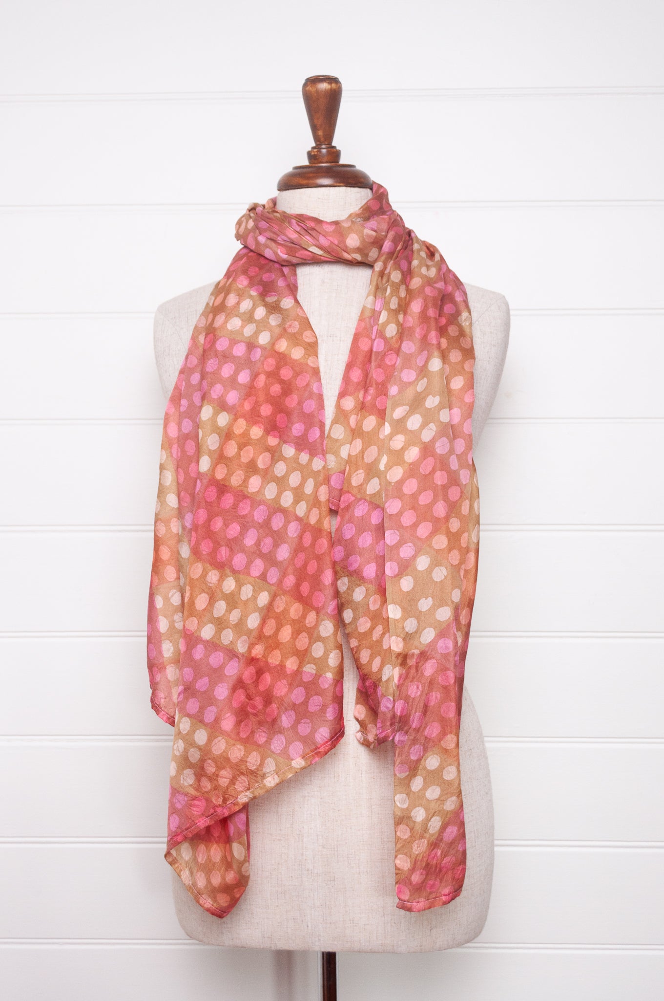Pure silk shibori dyed scarf in bands of pink and golden brown.