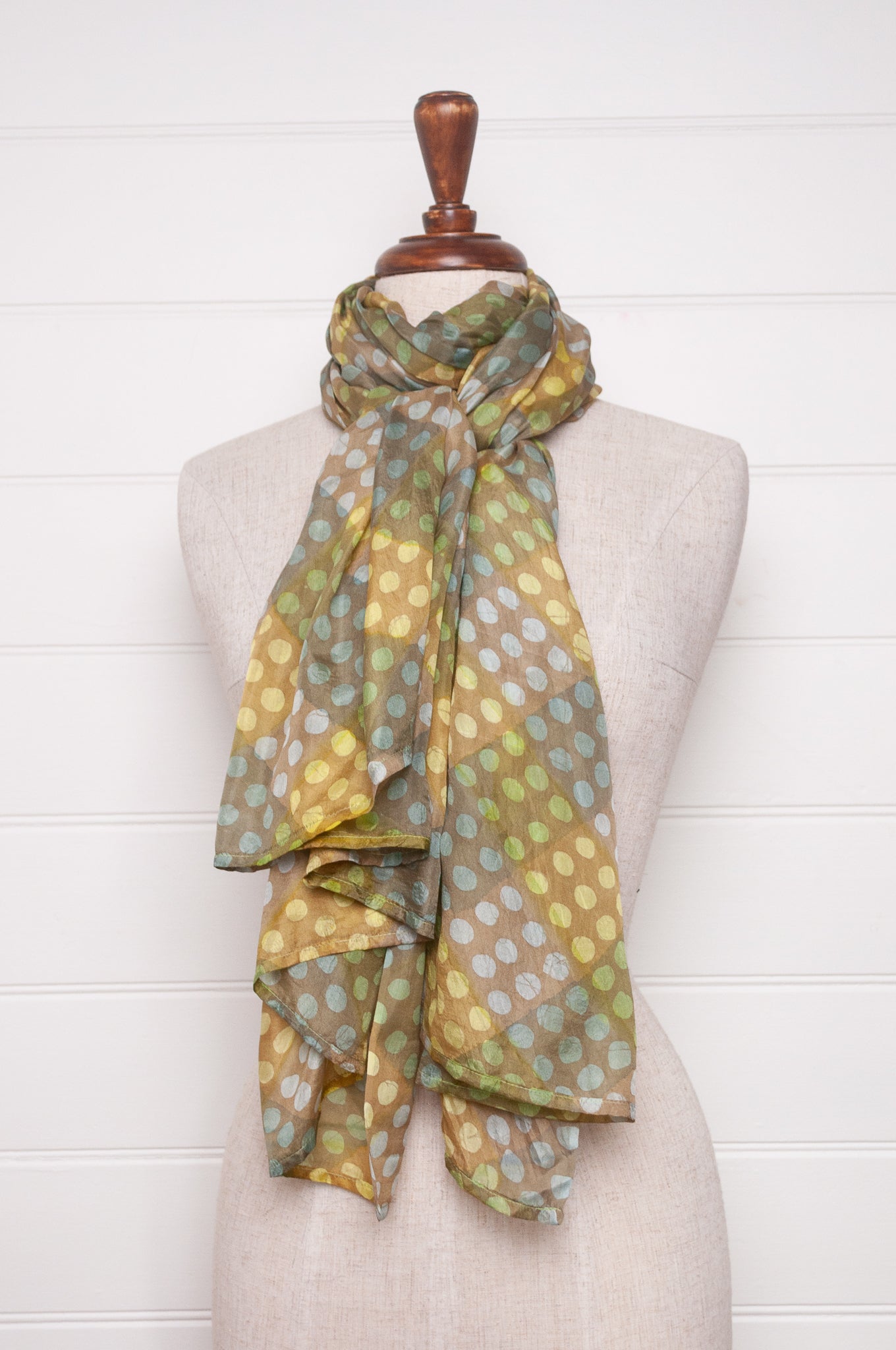 Pure silk shibori dyed scarf in bands of aqua and light olive.