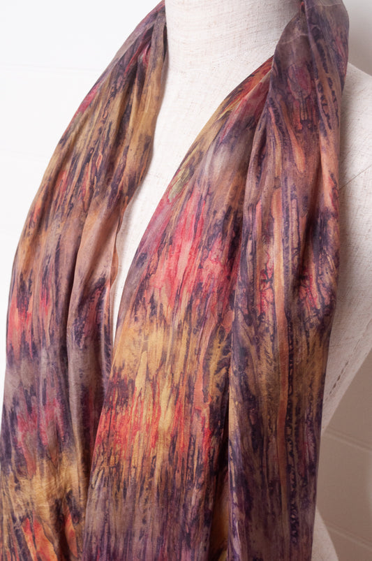 Pure silk shibori dyed scarf in shades of bronze, orange and purple.