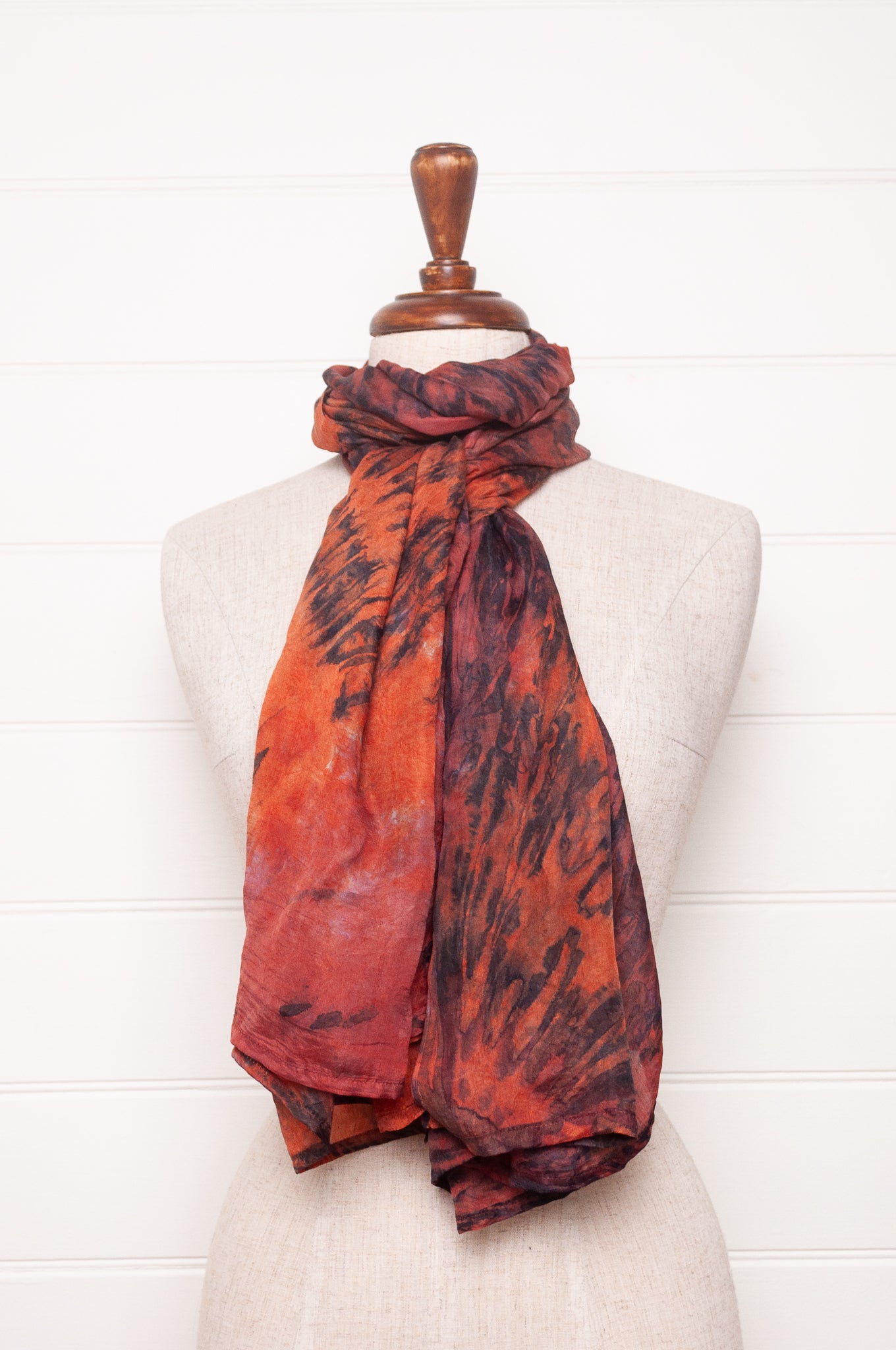 Pure silk shibori dyed scarf in shades of deep red, orange and brown.
