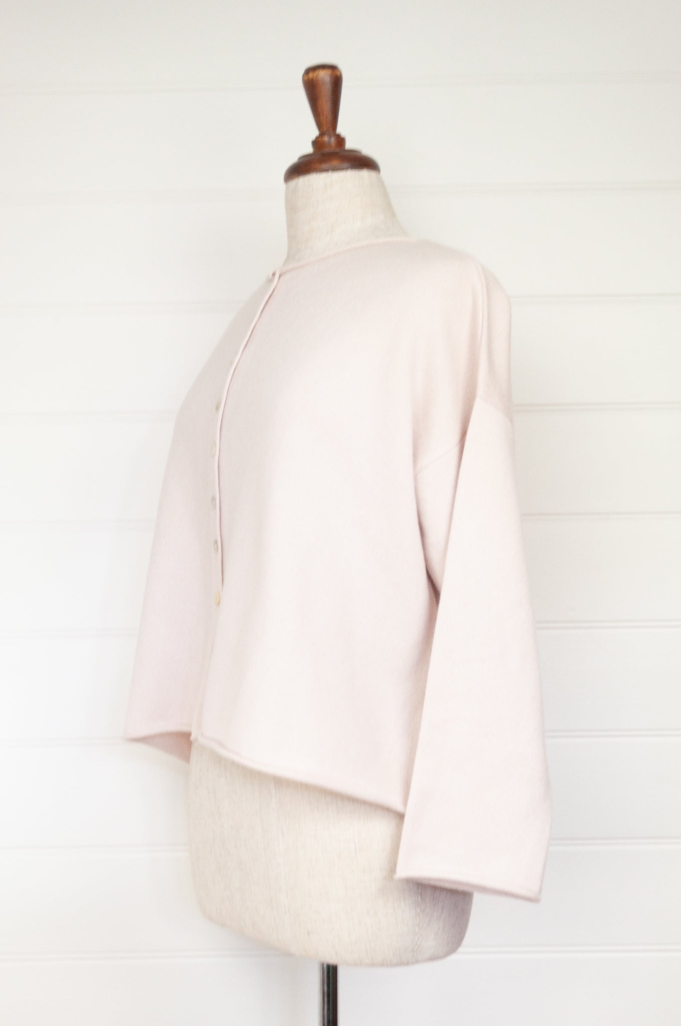Reversible ecru cashmere cardigan on mannequin.