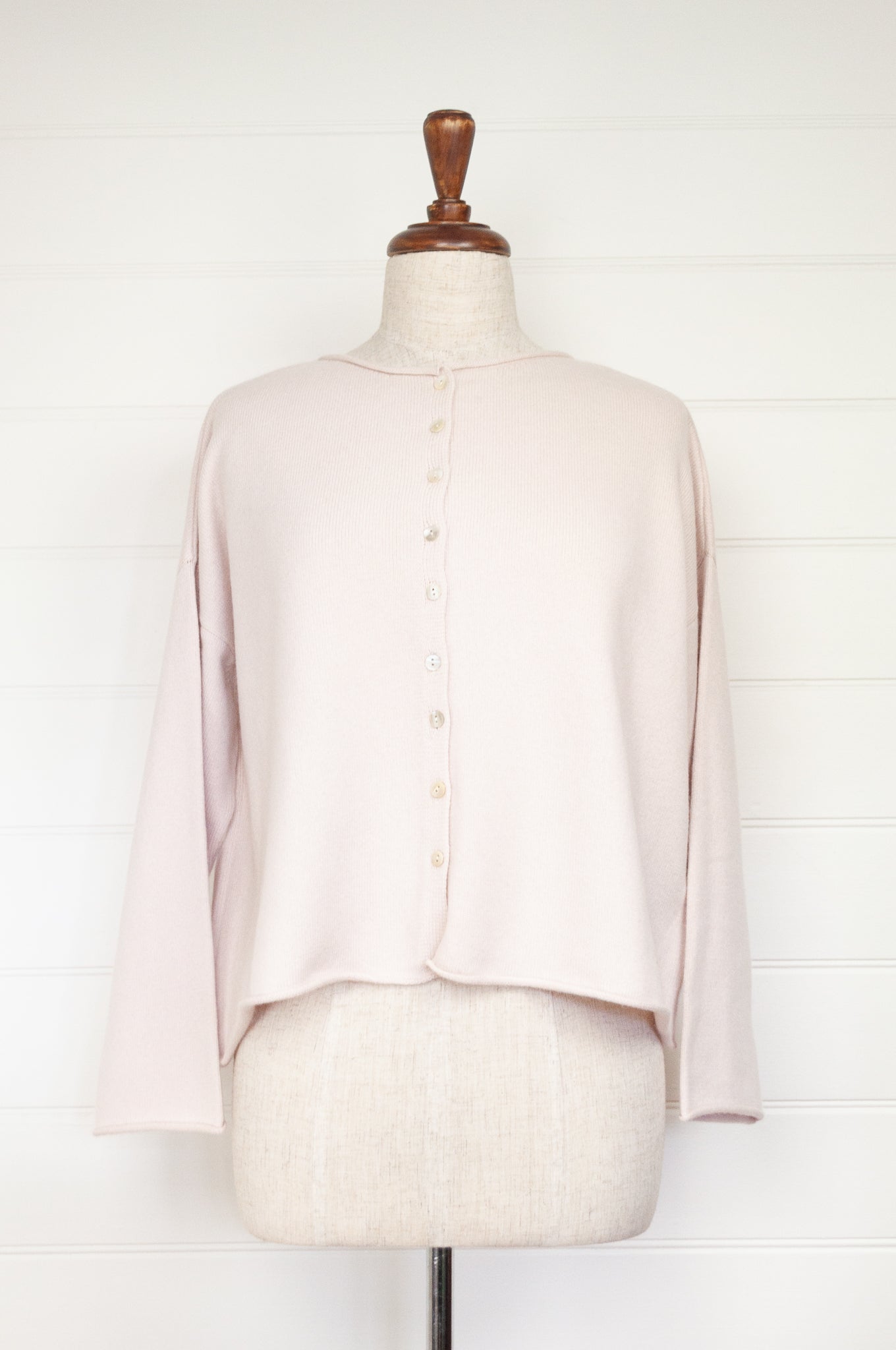 Reversible ecru cashmere cardigan on mannequin.