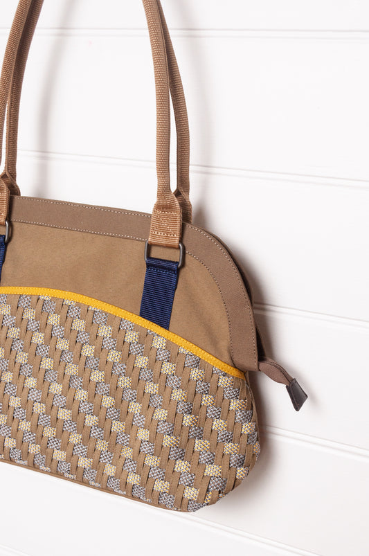 Anna Kaszer Fox bag in taupe, with double shoulder straps and woven braid panel.