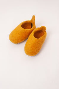 Wool felt baby slippers in mustard yellow.