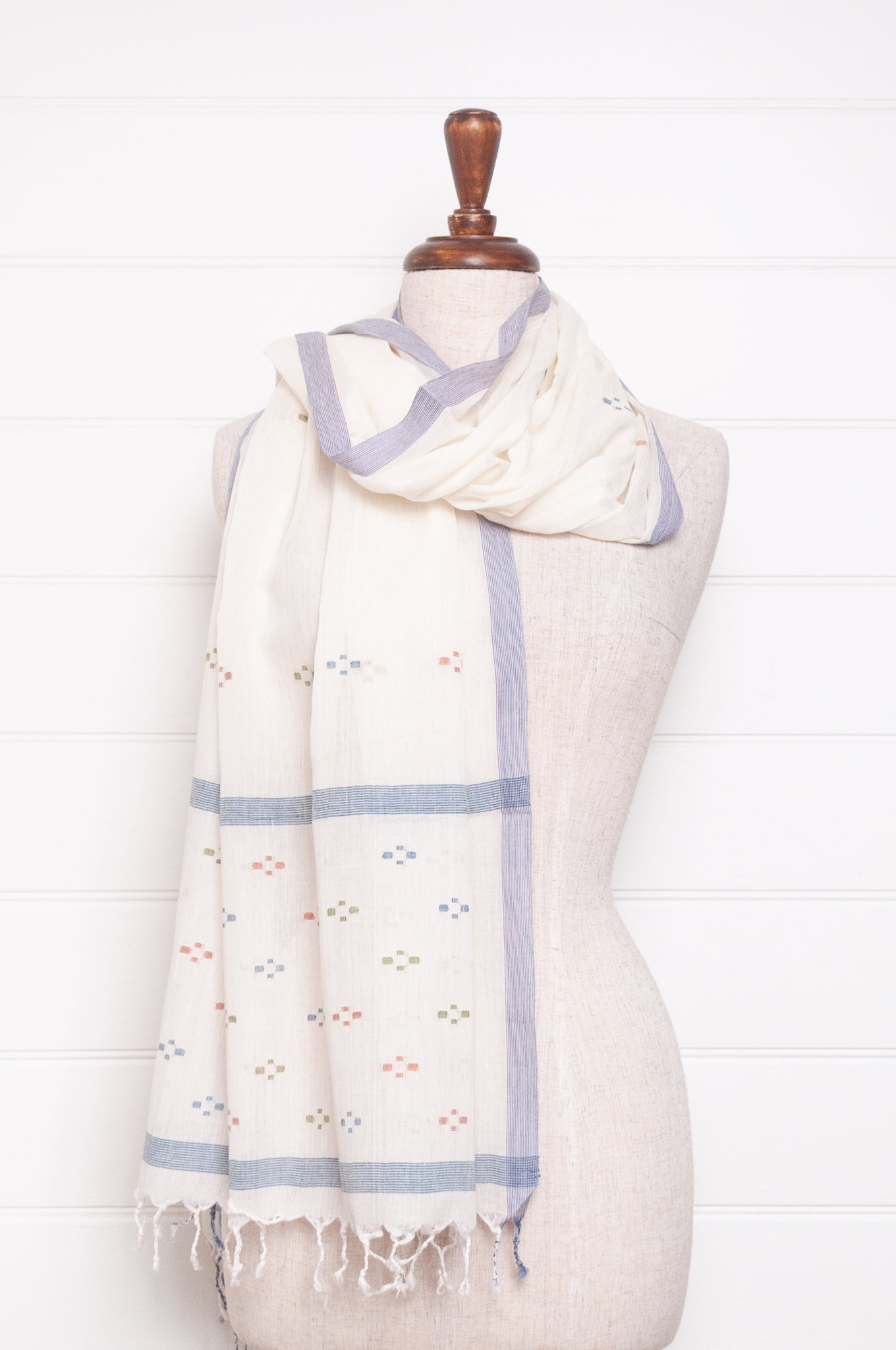 Handwoven light cotton jamdani scarf in ecru with multi-coloured motifs.