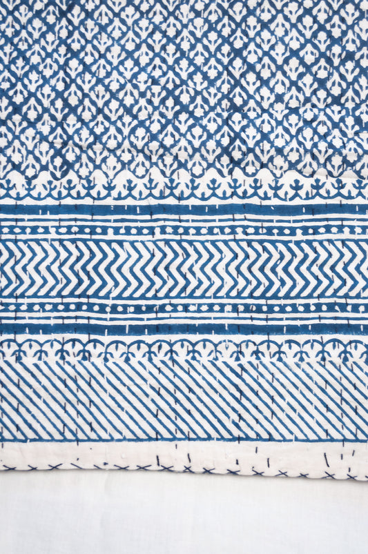 Cotton kantha quilt in indigo blue and white small floral.