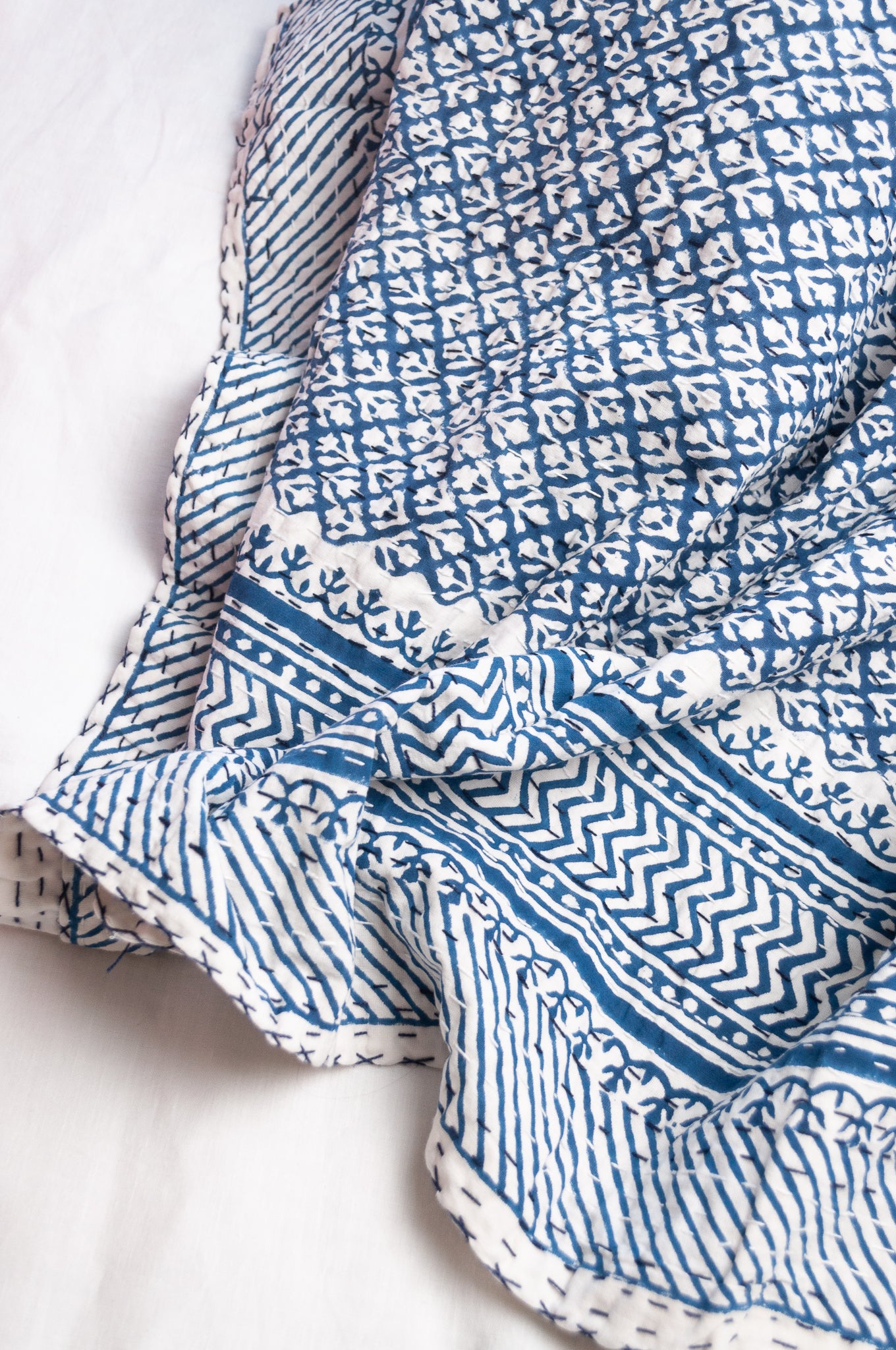 Cotton kantha quilt in indigo blue and white small floral.