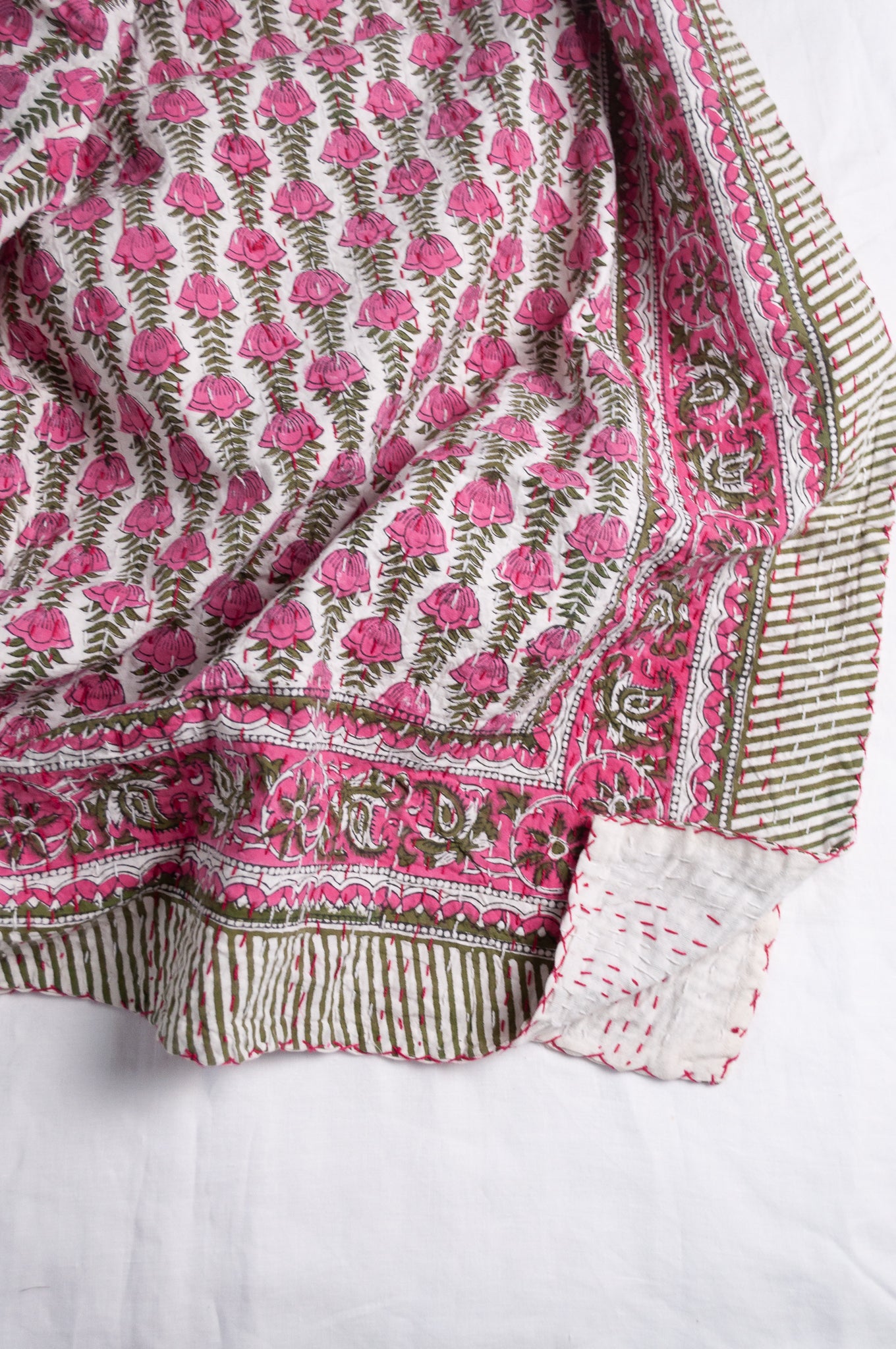 Pink green and white floral cotton kantha quilt.