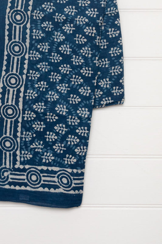 Blue and white indigo blockprint cotton sarong with sprigs and striped border.