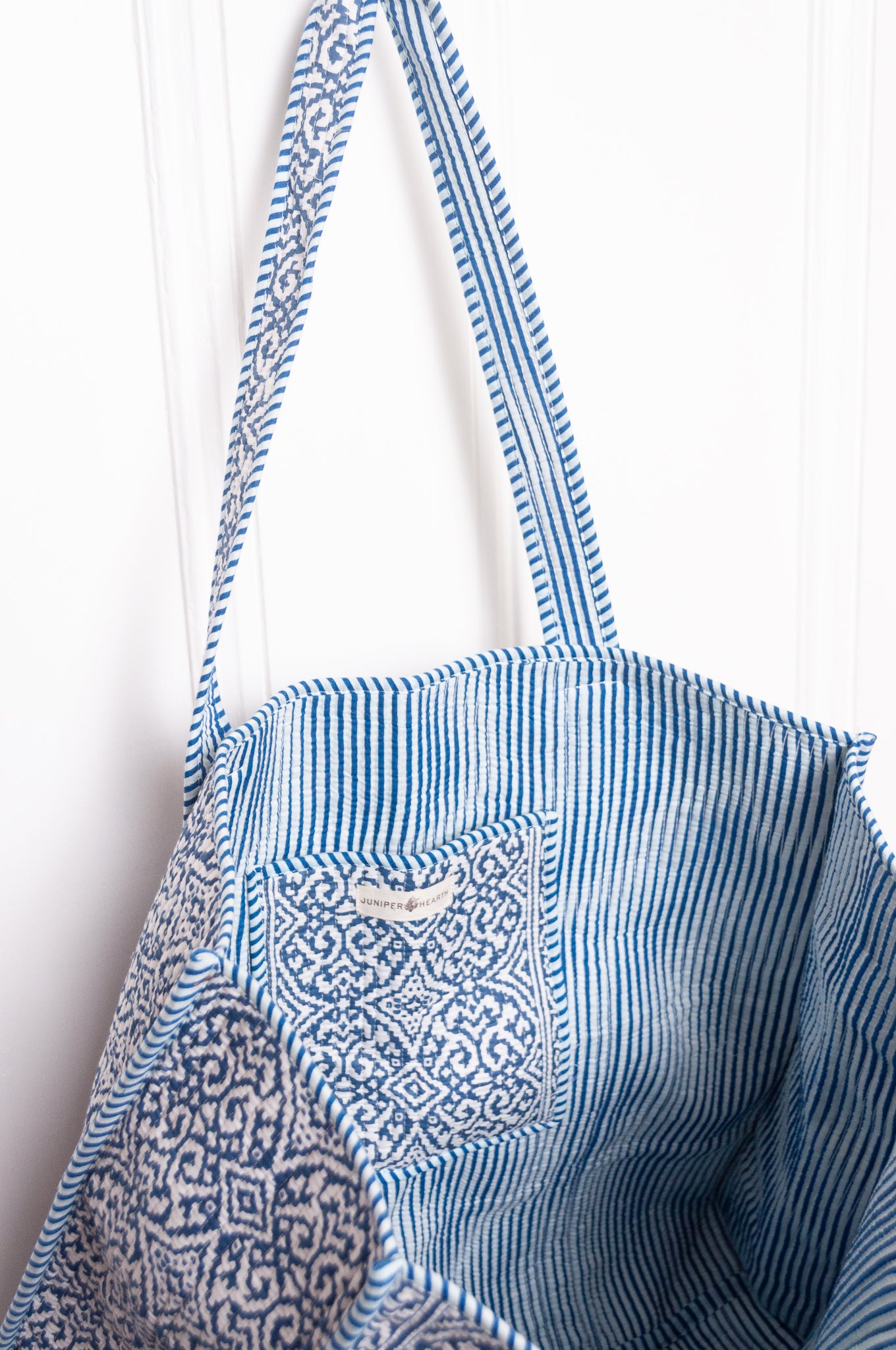 Blue and white quilted tote bag.